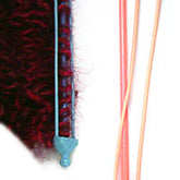 The image shows two Double-Ended Stitch Holders from Bryson Distributing, Inc. The one on the left is blue with red yarn looped around it, mimicking shoulder stitches, and it features decorative tops and bottoms. The one on the right is elongated and fork-shaped in a peach color, also showcasing similar decorative tops and bottoms.