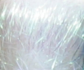 A close-up image shows an area covered in white or gray hair, with a high level of detail revealing individual strands and shimmering highlights caused by light reflection, reminiscent of the effect created by Foxglove Fiberarts Supply's Crystal Mylar Fiber on clearance.