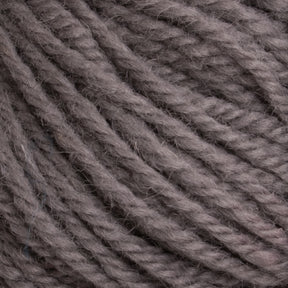 Close-up of a textured bundle of 100% Halcyon Deco Rug Wool yarn by Caledonian Dye Works in a greyish-brown color. The fibers are twisted together, creating a thick, sturdy appearance suitable for knitting or crocheting. The strands are slightly fuzzy, giving this Halcyon Deco Rug Wool yarn a soft and cozy look.