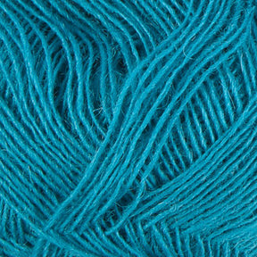 Close-up image of a ball of turquoise Einband Lopi yarn by Berroco, Inc., showing intricate textures and strands intertwined in a crisscross pattern. The fibers, reminiscent of delicate lace knitting, are soft and slightly fuzzy, capturing light and shadow within the weave.