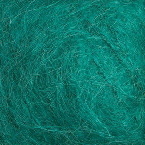 Close-up image of the Victorian Brushed Mohair Yarn | Mini Skein in a rich teal hue, crafted by Caledonian Dye Works. The tangled fibers, reminiscent of luxurious mohair, form a complex, textured surface. The strands are intertwined and overlapping, creating a dense, intricate pattern.