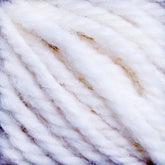 Close-up image of thick, white, and fluffy strands of Halcyon Yarn Classic Rug Wool from Caledonian Dye Works twisted together. The texture appears soft and woolly, with some fuzzy fibers visible on the surface, ideal for rug weavers.