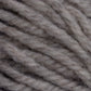 The Halcyon Yarn Classic Rug Wool by Caledonian Dye Works showcases close-up, thick, twisted strands of off-white yarn. The texture is soft and slightly fuzzy, with some individual fibers visible. This natural rug wool appears to be un-dyed, offering variations in thickness and color perfect for weavers seeking authenticity.