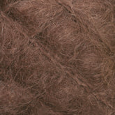 Close-up of tangled, light brown strands with a fibrous texture. The image shows a dense, hairy surface that could be luxurious Caledonian Dye Works' Victorian Brushed Mohair Yarn | Large Skein from Halcyon Yarn, offering a coarse and intertwined appearance reminiscent of traditional Victorian yarns.