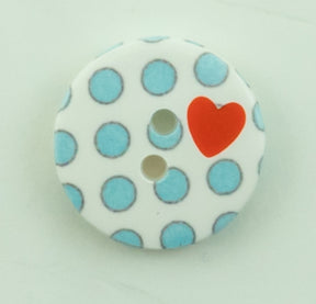 Introducing the Dots Button by Buttons Etc.: a 5/8" plastic button featuring two holes, decorated with charming light blue polka dots and accented by a single red heart near the holes, all set against a simple light background.