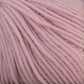 Close-up photo of Baby Blatt by Anny Blatt. This soft, thick yarn in a pale pink hue features slightly fuzzy strands and a clearly visible twist. Offered by Essentially Felt Studio & Fine Yarn, this machine washable baby yarn appears cozy and smooth, making it ideal for knitting or crocheting warm garments and accessories.