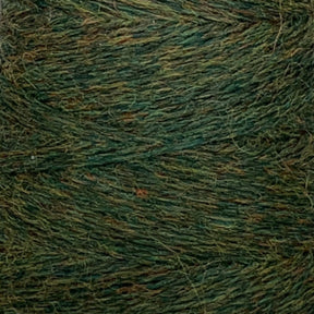 Close-up of a spool of JaggerSpun Heather 3/8 yarn by Jagger Brothers, Inc., displaying its intertwined green and brown heathered fibers with a textured, fuzzy appearance. The worsted spun wool yarn exhibits a blend of earthy tones, offering a rustic and natural feel, perfect for knitting or crocheting projects.