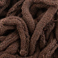 Close-up view of a pile of Harrisville Potholder Loops - Traditional Size Mini Pack by Friendly Loom, showcasing the thick, brown intertwined strands that highlight the texture and weave pattern, reminiscent of cotton loops woven on a traditional loom.