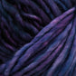 Close-up image of thick, wool yarn in various shades of purple, ranging from deep violet to lighter lavender. The Malabrigo Mecha hand dyed yarn from Malabrigo Yarn appears soft and slightly fuzzy, indicative of its suitability for knitting or crochet projects.