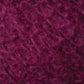 A close-up image of soft, textured burgundy yarn from Caledonian Dye Works' Victorian Bouclé Mohair Yarn collection. The fibers appear fluffy and intertwined, giving a rich, detailed look reminiscent of luxurious Mohair Bouclé.