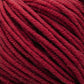 Close-up image of thick, red yarn from Plymouth Yarn Co.'s Plymouth Select Worsted Merino Superwash, showing individual strands tightly wound together. The texture appears soft and slightly fuzzy, suggesting the yarn is ideal for knitting or crocheting cozy garments or accessories with excellent stitch definition.