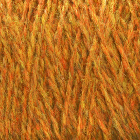 Close-up image of Harrisville Designs' Harrisville Shetland Yarn - Unwashed Cones in orange and yellow. The fibers are interwoven with visible variations in shade, showcasing a fuzzy and soft appearance. Perfect for lightweight blankets or intricate Fair Isle knitting designs, the overall texture looks warm and slightly shaggy.