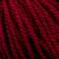 Close-up of thick, twisted strands of deep red Aran weight Norumbega yarn by Caledonian Dye Works. The texture of the 100% U.S. wool is soft and fibrous, with visible strands braided together to form a cohesive and dense bundle. The rich, vibrant color is consistent throughout the durable fabric.