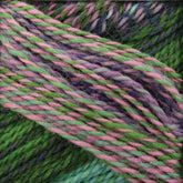 Close-up of a skein of Skacel's Zauberball Crazy Sock Yarn with intertwined strands in vibrant hues of green, pink, and purple. The texture is detailed, highlighting the twisted fibers and various color changes blending harmoniously.