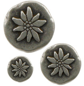 Three round Tin Poinsettia Buttons from Dill Buttons of America, Inc., in silver metal and varying sizes, showcase a raised daisy-like flower design with petal details and a textured center reminiscent of sand-cast pewter. The largest button is positioned at the top, with two smaller buttons below it.