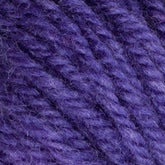 Close-up image of Halcyon Yarn Classic Rug Wool | Strand by Caledonian Dye Works in purple, showing detailed texture and individual fibers. The yarn, ideal for rug weavers, appears thick and soft, with a rich and consistent color reminiscent of classic rug wool.