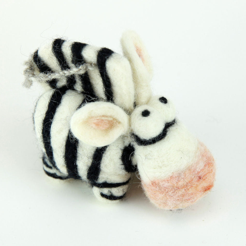 The Woolbuddy Needle Felting Kit from Woolbuddy allows you to create a small, whimsical felt zebra with charming black and white stripes. Standing on a white background, this handmade creation features an oversized head with a pink snout, large ears, and two small black eyes that contribute to its cute appearance. Expertly crafted using wool roving and felting needles, it showcases the high-quality needle felting work achievable with this kit.