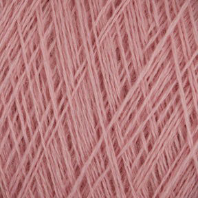 Close-up image of soft pink JaggerSpun Maine Line 2/20 yarns, neatly wound in a uniform pattern by Jagger Brothers, Inc. The texture of the medium-grade wool is slightly fuzzy, indicating its softness, and the consistent pattern showcases the meticulous winding of the threads on this large cone.