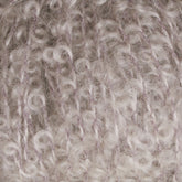 Close-up of a soft, knitted fabric with a curly, Victorian Bouclé Mohair texture. The yarn is a mix of white and light lavender hues, creating a cozy and intricate pattern throughout the material, reminiscent of Caledonian Dye Works' Signature Victorian Collection.