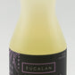 A 16.9 oz bottle of Eucalan Wool Wash is shown. The no-rinse, lanolin-enriched delicate laundry concentrate is lavender-scented. The semi-transparent yellow bottle features a black and lavender label with text in English and French, and contains 100% biodegradable fluid.