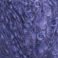 Close-up of a dense cluster of curly, purple fibers creating a soft, textured surface. The curls are tightly wound and intermingled, showcasing a variety of purple hues reminiscent of the Victorian Bouclé Mohair Yarn by Caledonian Dye Works, crafting a vibrant pattern worthy of Halcyon's Signature Victorian Collection.