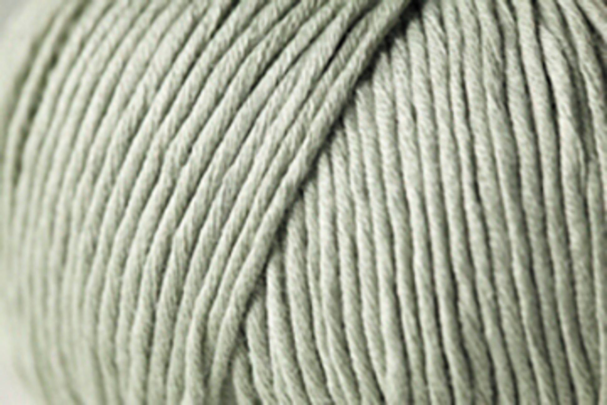 Close-up image of Kingfisher Yarn & Fibre's Jo Sharp Soho Summer DK Cotton, a large ball of light gray yarn tightly wound with a smooth texture and clearly defined strands—perfect as a lightweight cotton summer yarn.