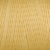 Close-up of a spool of Maurice Brassard's Medium Cotton 16/8 Mop Yarn in yellow, showcasing the texture and tight, uniform arrangement of the fibers. The yarn appears soft and is ideal for knitting, with consistent thickness throughout.