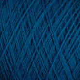 Close-up of tightly wound JaggerSpun Maine Line 3/8 Yarn | Large Cone from Jagger Brothers, Inc., showing the intricate crisscross pattern of the threads. The texture is soft and fibrous, with subtle variations in the hue of the blue strands. The image highlights the detailed structure of this soft, medium grade wool.