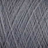 Close-up of a ball of grey JaggerSpun Maine Line 2/20 Yarn | Large Cone by Jagger Brothers, Inc. The yarn strands are tightly wound together, creating a dense and textured pattern. The medium grade wool appears slightly fuzzy, indicative of a soft material. The image highlights the intricate details of the yarn's texture and weaving.