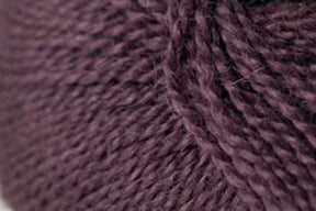 Close-up image of a ball of Jo Sharp Alpaca Kid Lustre from Kingfisher Yarn & Fibre, showcasing the tightly spun fibers and soft texture in its dark purple hue, perfect for knitting or crocheting.