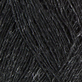 Close-up image of dark grey Einband Lopi yarn by Berroco, Inc., showcasing the texture and intricate weave of the fibers. The yarn appears thick and slightly fuzzy, with light catching on some strands to highlight its natural sheen. Perfect for lace knitting or stranded colorwork projects.