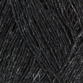 Close-up image of dark grey Einband Lopi yarn by Berroco, Inc., showcasing the texture and intricate weave of the fibers. The yarn appears thick and slightly fuzzy, with light catching on some strands to highlight its natural sheen. Perfect for lace knitting or stranded colorwork projects.