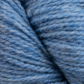 Close-up of thick, soft, light blue yarn fibers twisted together, showcasing the texture and individual strands. The sustainable Patagonia Organic Merino by Juniper Moon Farm yarn from Knitting Fever / Euro Yarns features a slightly fuzzy appearance, indicative of Organic Merino Wool, ideal for knitting and weaving projects.