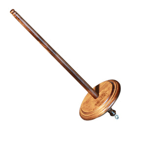 The Kromski North America Kromski Top Whorl Drop Spindle features a wooden spindle with a long, slender rod and a round base. The base boasts a simple, smooth design and includes a small metal hook at the bottom, making it perfect for spinning fibers. The image is isolated against a plain white background.