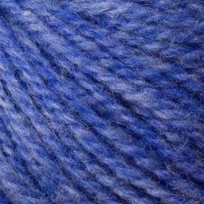 Close-up image of Bartletts Maine Wool - Sport by Bartlettyarns in blue, featuring shades ranging from light to dark. The texture is soft and fuzzy, with individual fibers visibly intertwined, creating a rich, colorful pattern suitable for knitting or crafting projects.