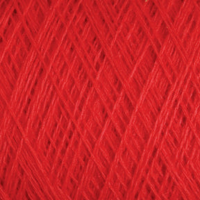 Close-up view of a tightly wound ball of vibrant red JaggerSpun Maine Line 3/8 Yarn | Mini-cone by Jagger Brothers, Inc. The fibers create a textured pattern of intersecting lines, highlighting the intricate weaving and soft, fibrous material throughout the image.