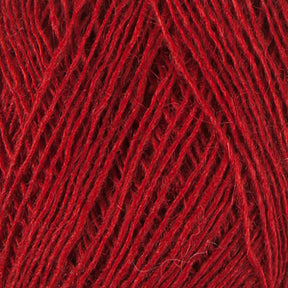 Close-up view of Einband Lopi yarn by Berroco, Inc. The threads are loosely wound together, showcasing the texture and fibers in the Icelandic wool. The vibrant red color is uniformly distributed across the strands, perfect for intricate lace knitting projects.