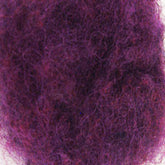 A close-up image of a textured purple felt surface. The fibers, densely packed with Harrisville Dyed & Carded Wool Fiber from Harrisville Designs, create a colorful and fuzzy appearance. The heathered colors of purple vary slightly throughout the felt, giving it a rich and vibrant look.