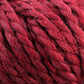 Close-up of thick, red strands of Baby Alpaca Grande by Plymouth, twisted together. This bulky weight yarn from Plymouth Yarn Co. features a slightly fuzzy texture with hints of different shades of red, giving it a rich, ultra-soft multi-dimensional appearance.