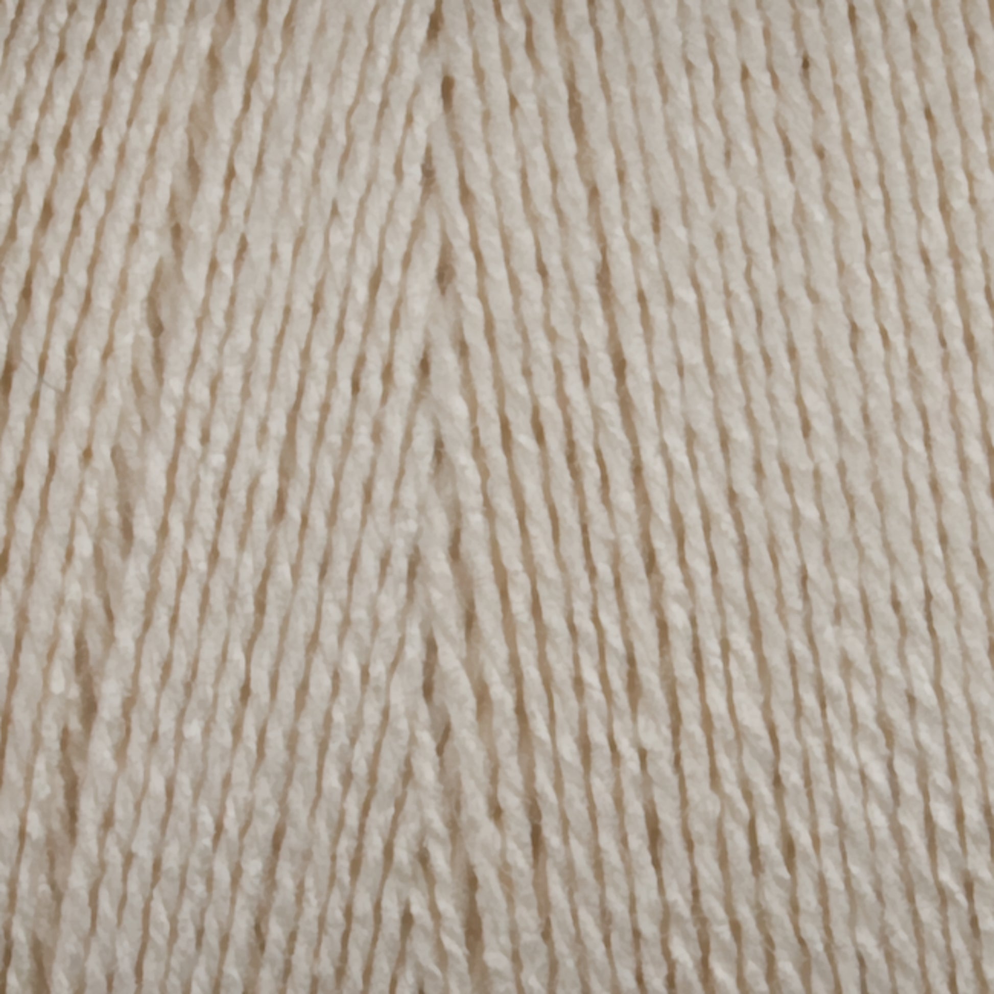 Close-up of Maurice Brassard's 8/2 Bamboo Yarn mini-cone fibers arranged in parallel lines, showcasing their cream-colored texture and thickness. The yarn appears soft and slightly glossy, indicating a smooth, high-quality material suitable for knitters or crocheters seeking environmentally friendly options.