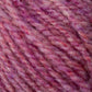 Close-up of a skein of Bartletts Maine Wool - Sport yarn from Bartlettyarns featuring a blend of pink, purple, and red hues. The yarn is thick and textured, showcasing a mix of light and dark shades that create a marbled effect. The fibers appear soft and fluffy.