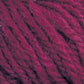 Close-up of the thick, textured "Halcyon Yarn Classic Rug Wool | Skein" by Caledonian Dye Works in a rich, deep magenta color. The tightly twisted strands showcase a slightly fuzzy texture with some individual fibers standing out. Hand-dyed and perfect for weavers, the color and feel suggest softness and warmth, making it ideal for knitting or crocheting projects.