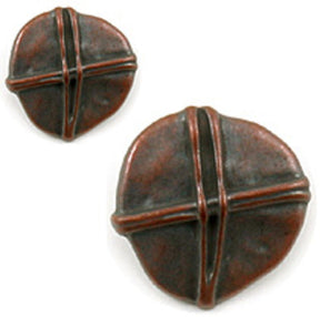 Close-up of two round, dark brown ceramic pieces from Dill Buttons of America, Inc., featuring the Copper Rustic Button design. Both pieces have a symmetrical pattern with crossed lines forming a raised "X" shape, similar to copper-colored buttons. The larger piece is in the foreground, while the smaller piece is positioned above and to the left.