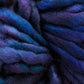 Close-up of thick, intertwined strands of Malabrigo Rasta by Malabrigo Yarn in varying shades of blue and purple. The fibers appear soft and fluffy, creating a cozy and textured appearance perfect for quick-to-knit projects.