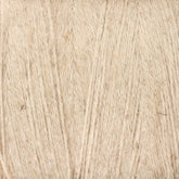 Close-up of a spool of beige Maurice Brassard 8/2 Cottolin Organic Yarn. The texture is slightly rough and fibrous, with small variations in color and thickness visible throughout, reminiscent of fabrics woven on a four shaft loom, possibly part of a Cottolin Tea Towel Kit.