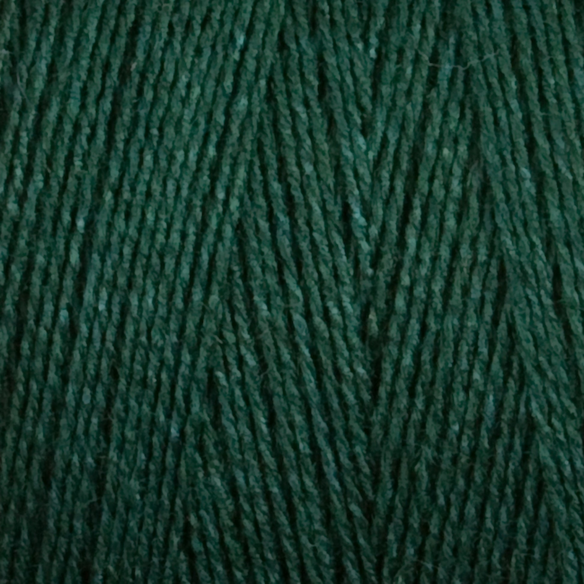 Close-up image of Maurice Brassard's 8/2 Tencel Yarn | Mini Cone in rich forest green. The tightly wound strands create a textured pattern, showcasing the intricate details of the interwoven fibers. Perfect for knitting accessories.