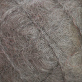 Close-up of a thick, tangled mass of fibers in varying shades of gray and brown, resembling a ball of luxurious Victorian Brushed Mohair Yarn | Mini Skein from Caledonian Dye Works. The texture appears rough and matted, reminiscent of Victorian yarns.