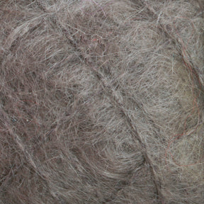 Close-up of a thick, tangled mass of fibers in varying shades of gray and brown, resembling a ball of luxurious Victorian Brushed Mohair Yarn | Mini Skein from Caledonian Dye Works. The texture appears rough and matted, reminiscent of Victorian yarns.