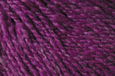 Close-up view of a textured DK weight yarn in shades of purple and pink. The fibers are thick and twisted together, giving the yarn a rich, vibrant appearance reminiscent of Jo Sharp Silkroad DK Tweed by Kingfisher Yarn & Fibre.