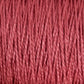 Close-up image of multiple strands of 10/2 Pearl Cotton Yarn | Mini-cone from Supreme Corp. in a beautiful rose color tightly wound together. The yarn fibers appear soft with a slight sheen, giving the overall appearance a rich, textured quality. This versatile yarn boasts excellent colorfastness, ensuring long-lasting vibrancy.